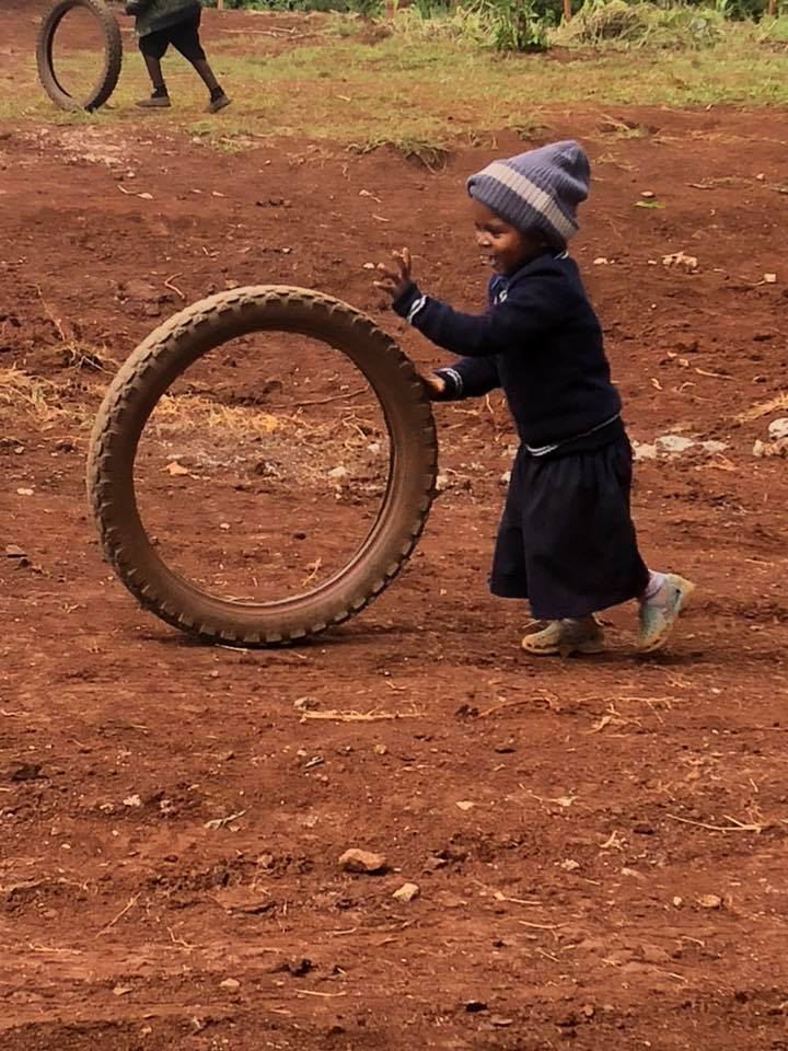 little girl with tire.jpg